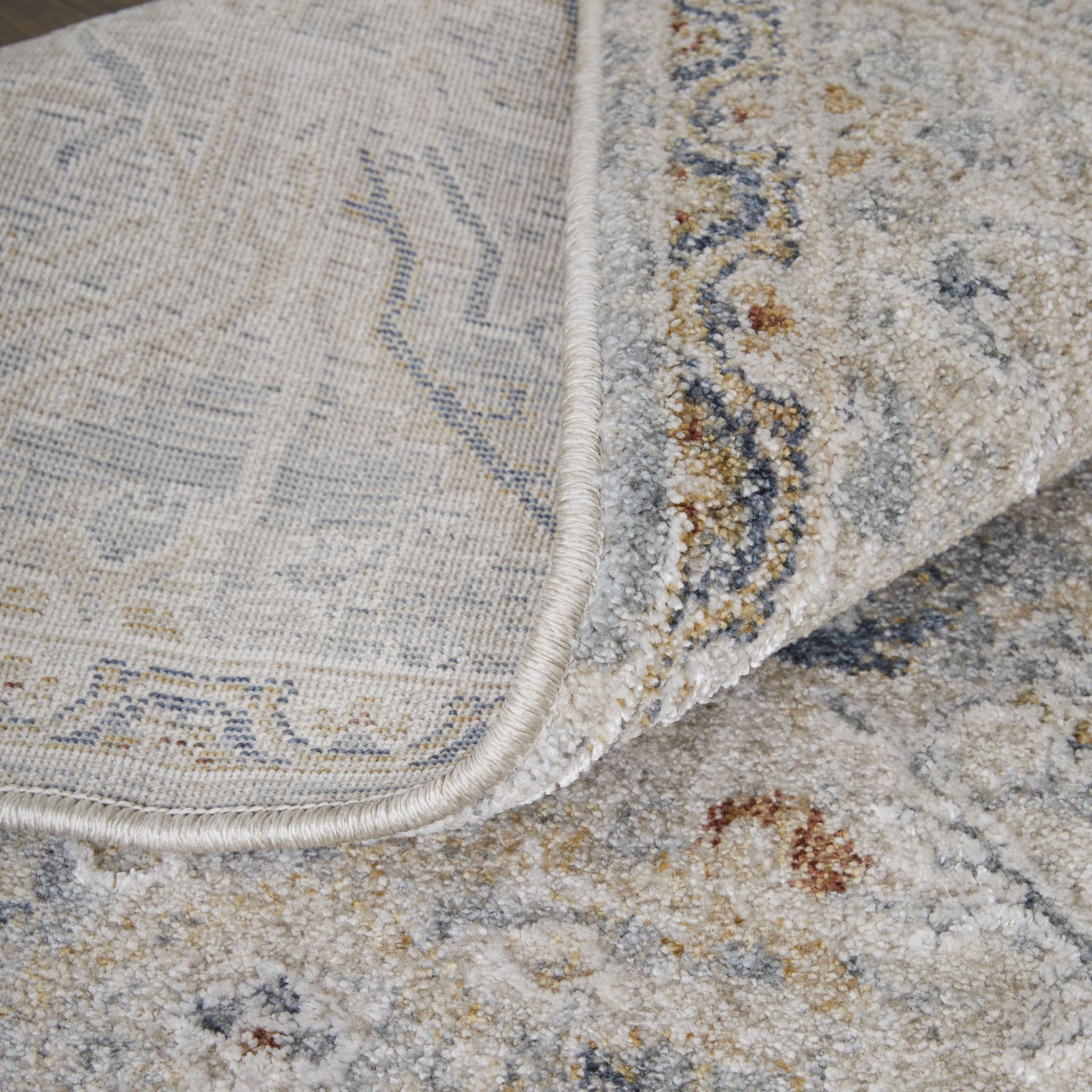 9" X 13" Ivory Tan and Blue Abstract Power Loom Worn Faded Area Rug With Fringe