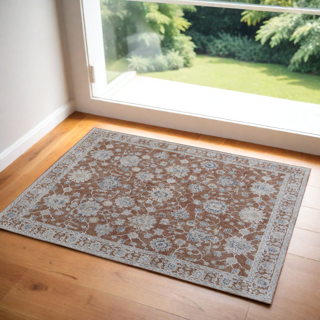 2" X 3" Red Blue and Ivory Floral Power Loom Worn Faded Area Rug With Fringe